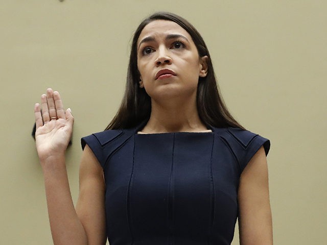 Rep. Alexandria Ocasio-Cortez, D-NY., stands to be sworn in before she testifies before th