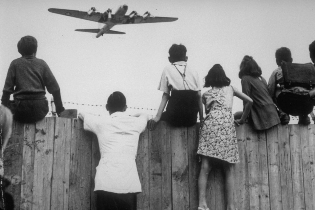 West Berlin children perched on the fence of Tempelhof airport watch the fleets of U.S. airplanes bringing in supplies in 1948 to circumvent the Russian blockade of land and waterways. The historic airlift began on June 25, 1948 and continued for 11 months. If one of the planes had been shot down, it could have meant war, but the U.S. decided to run that risk to save West Berlin from Joseph Stalin. (AP Photo/Henry Burroughs)