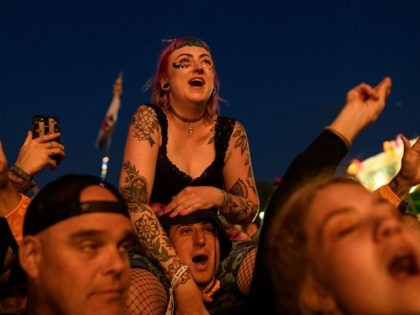 GLASTONBURY, ENGLAND - JUNE 29: Festival-goers react as The Killers perform on the Pyramid Stage on day four of Glastonbury Festival at Worthy Farm, Pilton on June 29, 2019 in Glastonbury, England. Glastonbury is the largest greenfield festival in the world, and is attended by around 175,000 people. (Photo by …