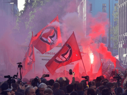 Participants of the "Revolutionary 1st of May Demonstration" light flares and wave flags of the left-wing, Anti-Fascist Antifa movement during May Day events on May 1, 2018 in Berlin. (Photo by John MACDOUGALL / AFP) (Photo by JOHN MACDOUGALL/AFP via Getty Images)