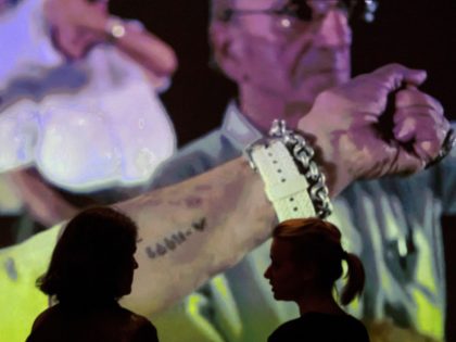 Former Nazi concentration camp Auschwitz survivors show their tattooed prisoners' numbers