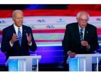 In this June 27, 2019, photo, Democratic presidential candidates former vice president Joe Biden and Sen. Bernie Sanders, I-Vt., speak at the same time during the Democratic primary debate hosted by NBC News at the Adrienne Arsht Center for the Performing Arts in Miami. (AP Photo/Wilfredo Lee)