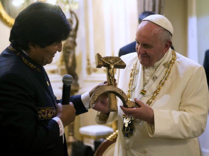 Bolivian President Evo Morales presents Pope Francis with a crucifix carved into a wooden hammer and sickle, in La Paz, Bolivia, Wednesday, July 8, 2015. The crucifix is a replica, originally designed by Jesuit activist Luis Espinal, who was assassinated in 1980 by suspected paramilitaries during the months that preceded …