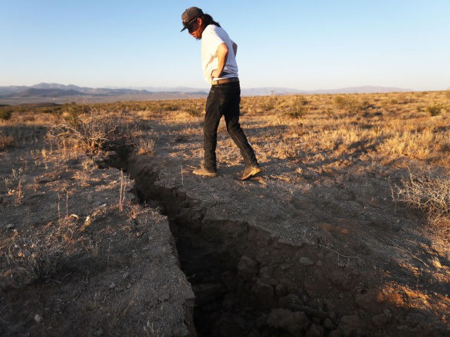 RIDGECREST, CALIFORNIA - JULY 04: A local resident inspects a fissure in the earth after a 6.4 magnitude earthquake struck the area on July 4, 2019 near Ridgecrest, California. The earthquake was the largest to strike Southern California in 20 years with the epicenter located in a remote area of …