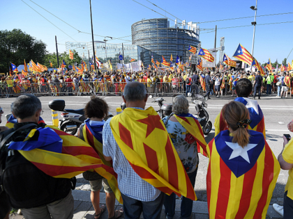 TOPSHOT - People wave Catalan pro-independence 'Estelada' flags and banners during a demonstration in front of the European Parliament on July 2 , 2019 in Strasbourg, eastern France. - Demonstrators protest in support of Catalan separatists unable to take seats as MEPs. (Photo by FREDERICK FLORIN / AFP) (Photo credit …
