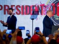 President Donald Trump, left, accompanied by Turning Point USA Founder Charlie Kirk, right, takes the stage at Turning Point USA Teen Student Action Summit at the Marriott Marquis in Washington, Tuesday, July 23, 2019. (AP Photo/Andrew Harnik)