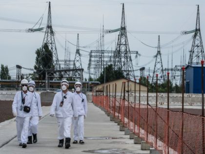 PRIPYAT, UKRAINE - JULY 2: Workers at the Chernobyl Nuclear Power Plant on July 2, 2019 in Pripyat, Ukraine. In November 2016, the 'New Safe Confinement' structure was shifted into place to prevent the decaying reactor from further contaminating the environment and eventually allow its dismantling; the Ukrainian government will …
