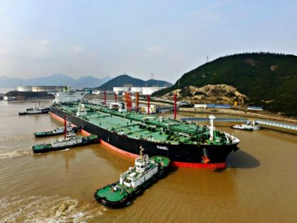 Tugboats dock the oil tanker “Daniel” carrying crude oil imported from Iran at the Port of Zhoushan in Zhoushan city, east China’s Zhejiang province, 8 March 2018. Imaginechina | AP Images