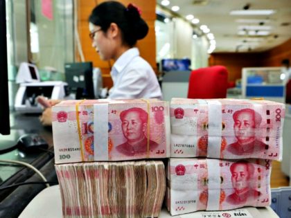 An employee counts 100-yuan notes at a bank in Nantong in China’s eastern Jiangsu province on July 23, 2018. (AFP/Getty Images)