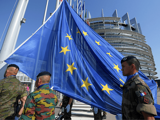 Soldiers of Eurocorps raise an European Union flag during the flag-raising ceremony on the eve of the inaugural session of new European Parliament on July 1, 2019 in front of Louise Weiss building (R), headquarters of the European Parliament in Strasbourg, eastern France. (Photo by FREDERICK FLORIN / AFP) (Photo …