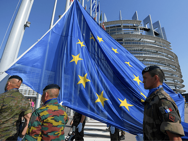 Soldiers of Eurocorps raise an European Union flag during the flag-raising ceremony on the