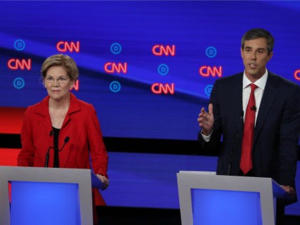Democratic presidential candidate former Texas congressman Beto O'Rourke (R) speaks while Sen. Elizabeth Warren (D-MA) listens during the Democratic Presidential Debate at the Fox Theatre July 30, 2019 in Detroit, Michigan. 20 Democratic presidential candidates were split into two groups of 10 to take part in the debate sponsored by …