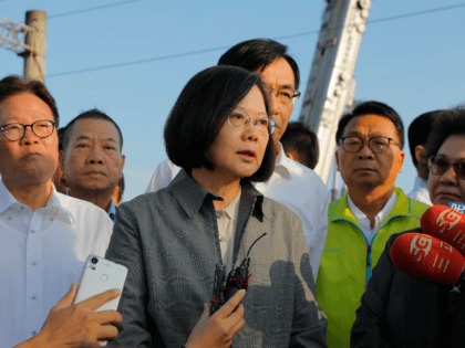 Taiwan's President Tsai Ing-wen (C) speaks after a briefing at Xinma station in Taiwan's northeastern Yilan county on October 22, 2018, a day after a Puyuma Express train derailed at high speed near the station. - At least 18 people have died after an express train derailed and flipped over …