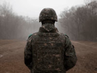 In a photo taken on December 3, 2018 a South Korean soldier stands before the Military Demarcation Line (MDL) separating North and South Korea, on the southern side of the Demilitarized Zone (DMZ) in South Korea's Cheorwon county. - North and South Korea have connected a road across their shared …