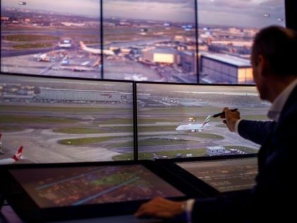 Air Traffic Control Engineers use screens displaying real-time panoramic views of the runw