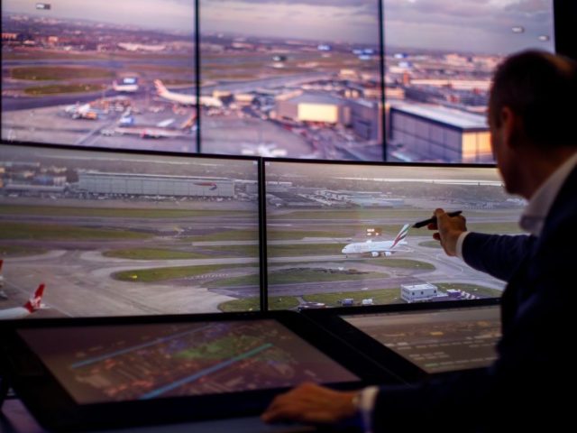 Air Traffic Control Engineers use screens displaying real-time panoramic views of the runways and docking gates, as they work on a non-operational trial in the NATS Digital Tower Laboratory, inside the control tower at London Heathrow Airport in west London on January 23, 2019. - Air traffic management service NATS …