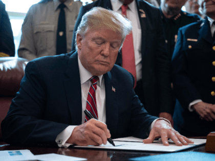 US President Donald Trump signs the first veto of his presidency, overriding a congressional resolution to secure emergency funds to build his much-vaunted wall on the US-Mexico border in the Oval Office at the White House in Washington, DC, on March 15, 2019. (Photo by NICHOLAS KAMM / AFP) (Photo …