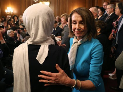 WASHINGTON, DC - MARCH 13: House Speaker Nancy Pelosi (D-CA) walks by Rep. Ilhan Omar (D-M