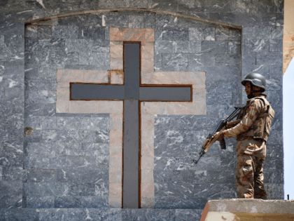 A Pakistani soldier stands guard on the roof of a Methodist Church during the Easter service in Quetta on April 21, 2019. - A series of eight devastating bomb blasts ripped through high-end hotels and churches holding Easter services in Sri Lanka on April 21, killing nearly 160 people, including …