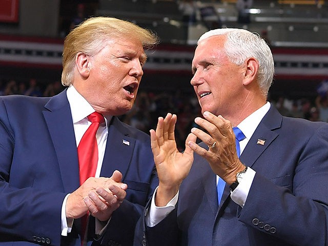 US Vice President Mike Pence speaks with US President Donald Trump at a rally to officiall