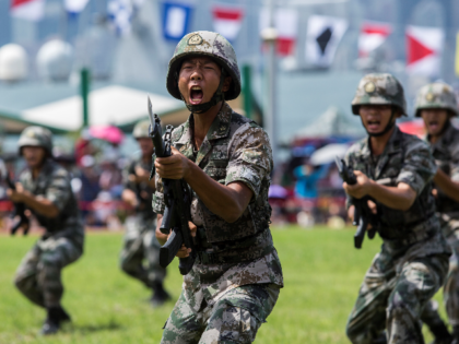 Soldiers of the Peoples' Liberation Army (PLA) perform drills during a demonstration at an open day at the Ngong Shuen Chau Barracks in Hong Kong on June 30, 2019, to mark the 22nd anniversary of Hong Kong's handover from Britain to China on July 1. (Photo by ISAAC LAWRENCE / …