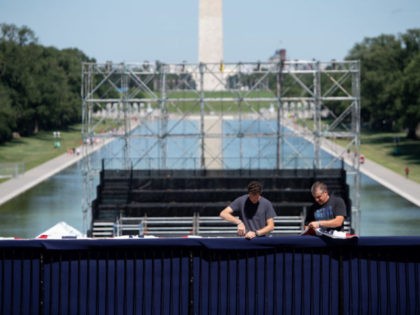 Workers hang patriotic bunting as they build a stage and bleachers for the "Salute to America" Fourth of July event with US President Donald Trump at the Lincoln Memorial on the National Mall in Washington, DC, July 1, 2019, which will feature flyovers by the Blue Angels, an airplane used …