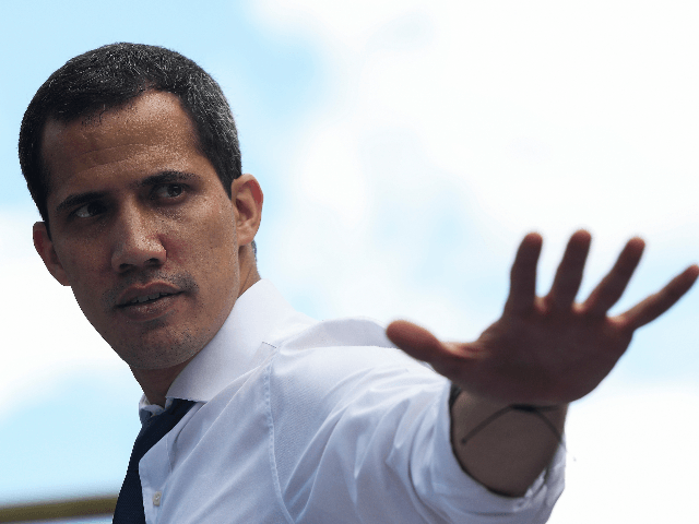 Opposition leader and president of the National Assembly Juan Guaido greets supporters dur