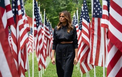 US First Lady Melania Trump walks through 453 American flags, each representing a child in foster care in Cabell County, West Virginia, many due to the opioid epidemic, at Ritter Park in Huntington, West Virginia, July 8, 2019. (Photo by SAUL LOEB / AFP) (Photo credit should read SAUL LOEB/AFP/Getty …