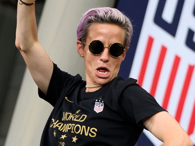 USA women's soccer player Megan Rapinoe (L) and other team members celebrate in front of t