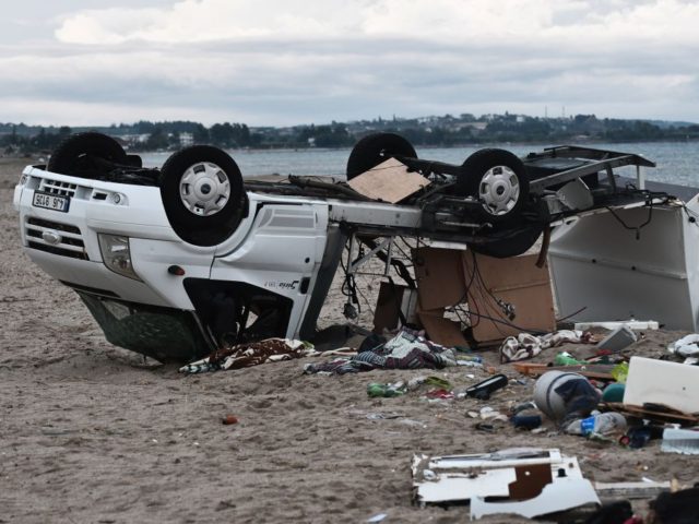 TOPSHOT - A caravan overturned by strong winds lies on a beach where a storm killed a Czec