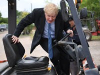 Conservative MP and leadership contender Boris Johnson drives a forklift truck during a leadership campaign visit to a nursery in Braintree, southeast England on July 13, 2019. - Britain's leadership contest is taking the two contenders on a month-long nationwide tour where they will each attempt to reach out to …