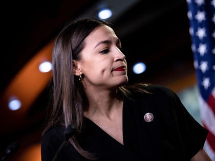 US Representative Alexandria Ocasio-Cortez (D-NY) listens during a press conference, to ad