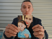 Sadam Abdusalam holds up a photo of his Uighur wife Nadila Wumaier and their baby son Lutifeier at a restaurent in Sydney's western suburbs on July 17, 2019. - Australia's government on July 17 called on China to allow an Australian child and his Uighur mother to leave the country, …