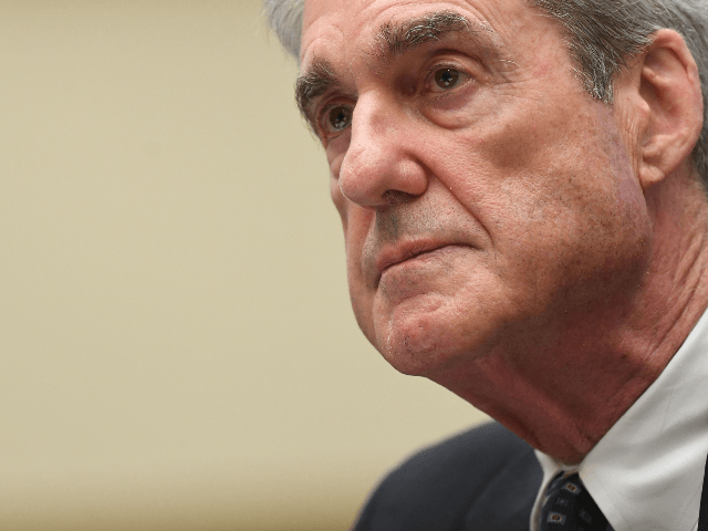 Former Special Counsel Robert Mueller listens as he testifies before the House Select Comm