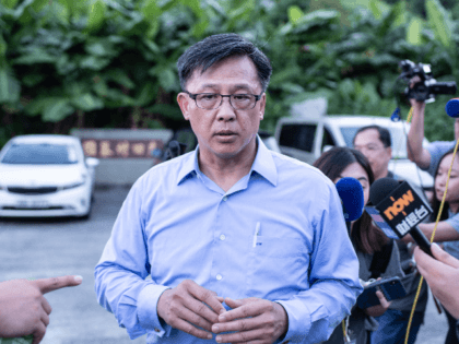 This picture taken on July 23, 2019 shows Hong Kong pro-Beijing government lawmaker Junius Ho leaving the cemetery after learning his parents' gravestones were vandalised in the Tuen Mun district of Hong Kong. - Hong Kong police on July 25 banned a planned protest against suspected triad gangs who beat …
