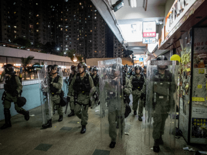 Riot police chase protesters through a shopping mall as they clash with protesters after taking part in a pro-democracy march on July 14, 2019 in Hong Kong, China. Thousands of protesters marched in Sha Tin district on Sunday as pro-democracy demonstrators continued weekly rallies on the streets of Hong Kong …