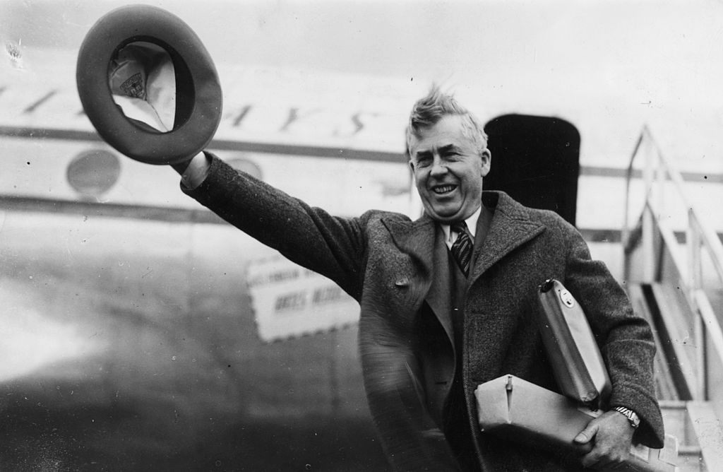 Henry A Wallace, former US Secretary of Commerce, waving his hat in the air as he arrives at London Airport, circa 1950. (Photo by J. Wilds/Keystone/Getty Images)