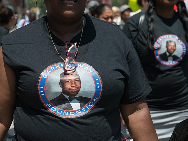 NEW YORK, NY - JULY 16: People wear t-shirts commemorating the two year anniversary of Eric Garner's death during a march on July 16, 2016 in the Brooklyn borough of New York City. Garner died in July 2014 after New York City police placed him in a chokehold during what …