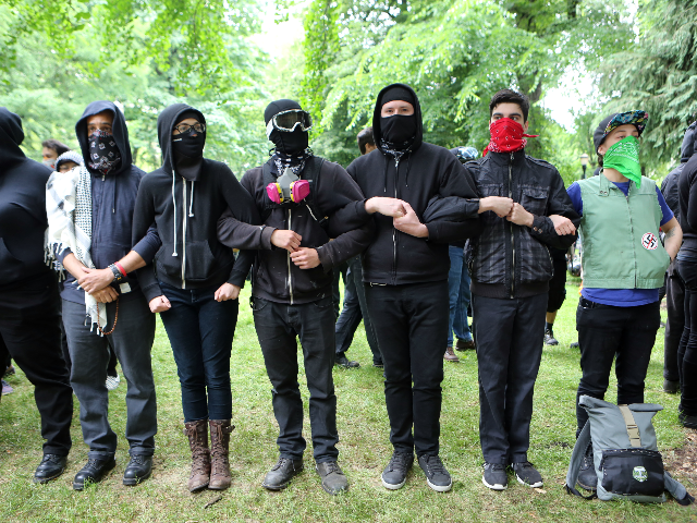 'Antifa' protesters link arms as they demonstrate at a rally on June 4, 2017 in Portland,