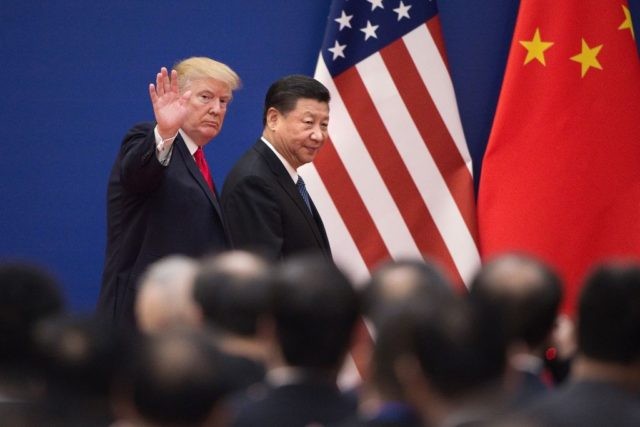 TOPSHOT - US President Donald Trump (L) and China's President Xi Jinping leave a busi