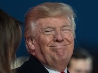 US President Donald Trump smiles as US Secretary of the Interior Ryan Zinke looks on during the 95th annual National Christmas Tree Lighting ceremony at the Ellipse in President's Park near the White House in Washington, DC on November 30, 2017. / AFP PHOTO / NICHOLAS KAMM (Photo credit should …