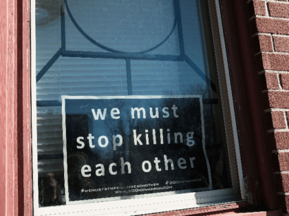 BALTIMORE, MD - FEBRUARY 03: A sign to end violence sits in a window in a neighborhood wit