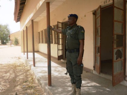 A policeman stands on guard at the premises of Government Girls Technical College, where 110 girls were kidnapped by Boko Haram Islamists at Dapchi town in northern Nigerian on February 28, 2018.