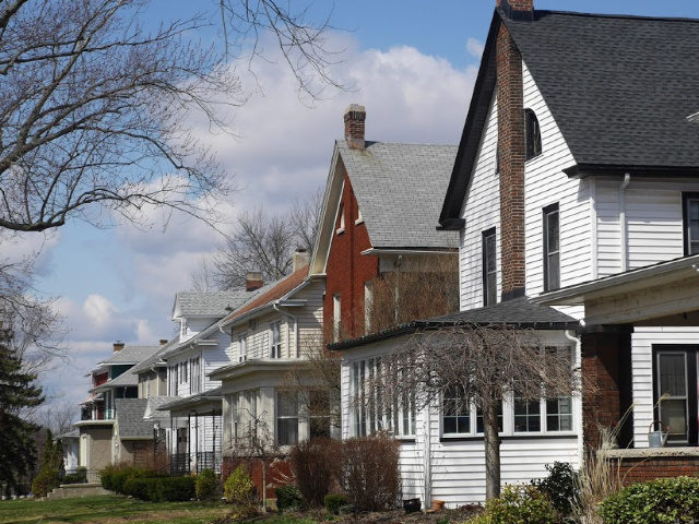 Row of middle-class houses on American suburban street - Getty Images stock photo.