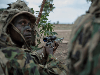 A member of the Nigerian Armed Forces Sniper Unit wearing a ghillie suit takes part in an exercise during the African Land Forces Summit (ALFS) military demonstration held at General Ao Azazi barracks in Gwagwalada on April 17, 2018. - The African Land Forces Summit (ALFS) is a weeklong seminar …
