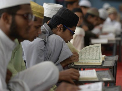 Indian Muslim students recite from the Quran in a classroom during the holy month of Ramad