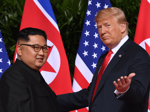 US President Donald Trump (R) gestures as he meets with North Korea's leader Kim Jong Un (