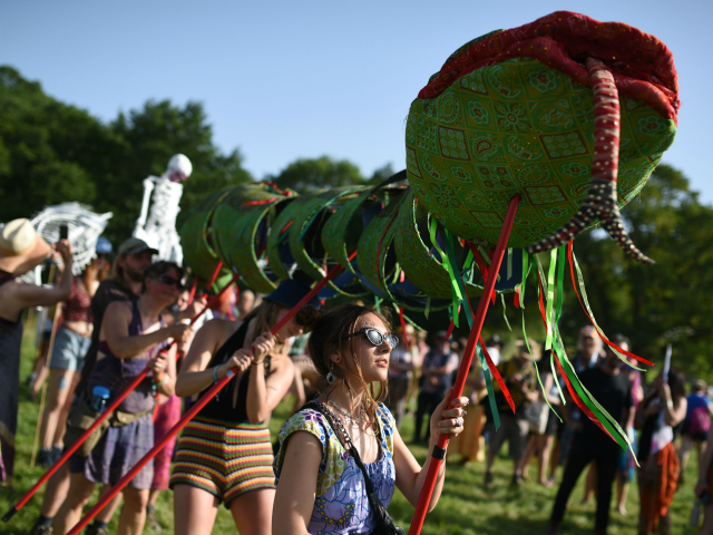 Protestors from Climate change group Extinction rebellion walk through Glastonbury Festiva