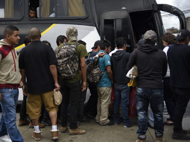 Guatemalan immigrants deported from the United States, get on a bus as they leave the Air Force base in Guatemala City on June 22, 2018. - A group of 108 Guatemalan immigrants who tried to cross illegaly to the US under the "zero tolerance" migratory policy where deported. (Photo by …