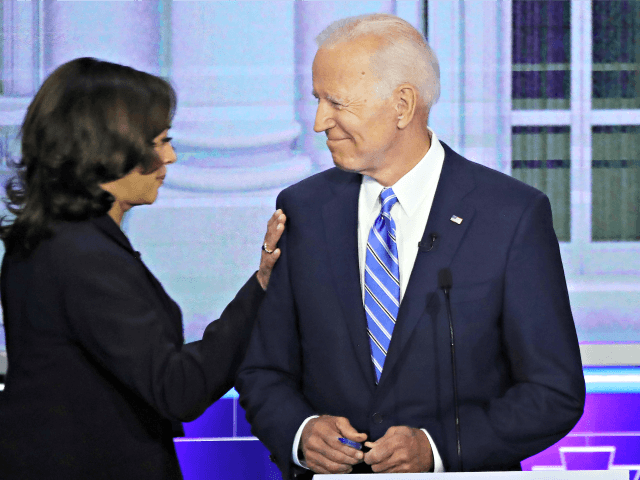 MIAMI, FLORIDA - JUNE 27: Sen. Kamala Harris (D-CA) touches former Vice President Joe Bide